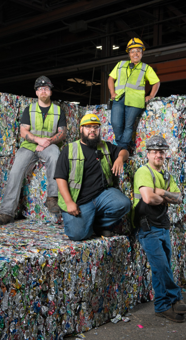 Group of people on bales of aluminum